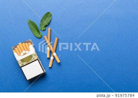 Pack of menthol cigarettes and fresh mint on colored table, Menthol cigarettes top view flat lay 91975784