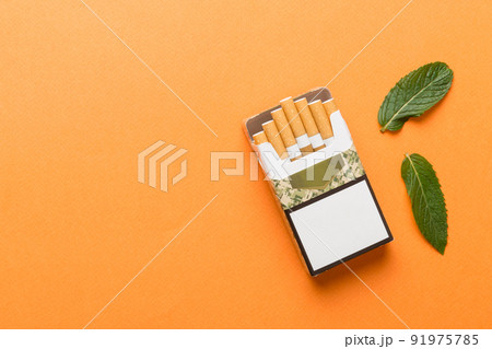 Pack of menthol cigarettes and fresh mint on colored table, Menthol cigarettes top view flat lay 91975785
