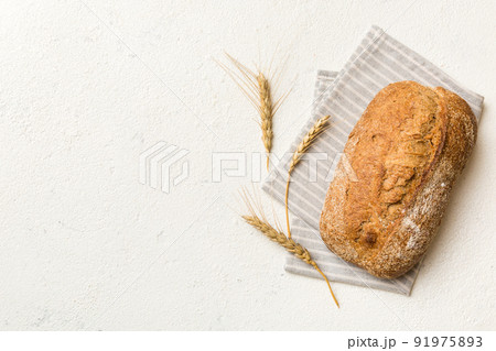 Fresh Homemade Whole Wheat Bread. bread on napkin on rustic background, fresh bread top view Fresh Homemade Whole Wheat Bread. bread on napkin on rustic background, fresh bread top view 91975893