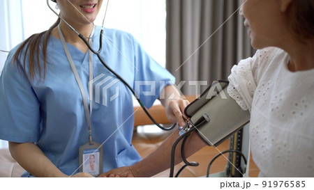 Asian elder woman visiting a specialist doctor to check up for health at general hospital. Asian female doctor talking to elder woman. 91976585