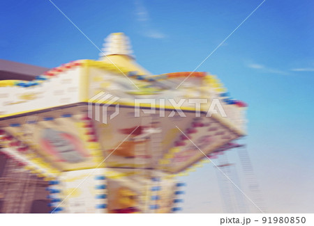 Fragment of colored childrens carousel in motion blur against blue sky during fun fair Fragment of colored childrens carousel in motion blur against blue sky during fun fair 91980850