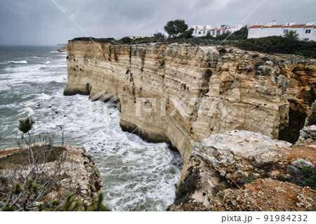 View from the mountain edge to the moody sky, raging Atlantic Ocean during stormy weather. Portugal View from the mountain edge to the moody sky, raging Atlantic Ocean during stormy weather. Portugal 91984232
