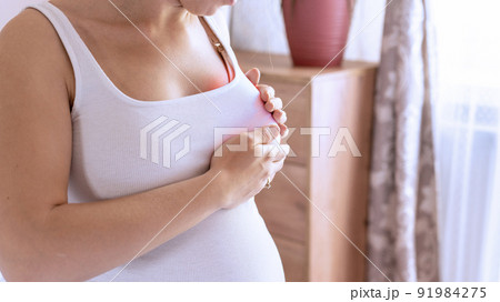 Breast exam cancer woman check. Happy young pregnant woman self exam. Breast self exam. Health, medicine and beauty concept. 91984275