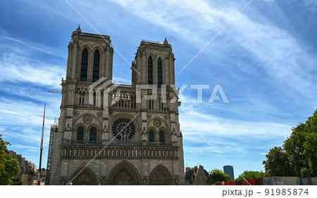 Paris, France. June 2022. Nice view of the Notre Dame facade. The crane of the restoration site is visible after the great fire that damaged the cathedral. Paris, France. June 2022. Nice view of the Notre Dame facade. The crane of the restoration site is visible after the great fire that damaged the cathedral. 91985874