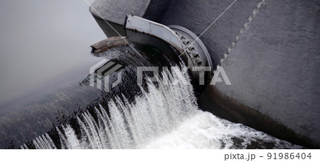 A picture of the flowing water. The dam is designed to regulate the water level in rivers within the city and to provide technical water to industrial objects 91986404