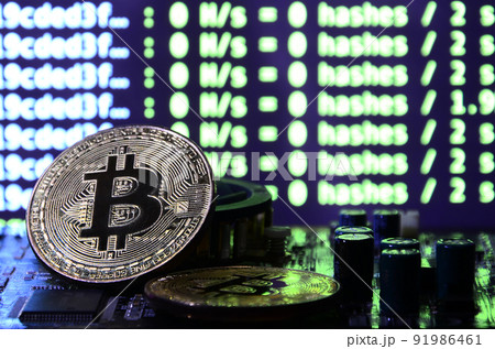 The digital process of cryptocurrency mining by using the GPUs. Bitcoins and video card on a working display and mining screen The digital process of cryptocurrency mining by using the GPUs. Bitcoins and video card on a working display and mining screen 91986461