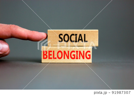 Social belonging symbol. Wooden blocks with concept words Social belonging on beautiful grey background. Businessman hand. Business political social belonging concept. Copy space. Social belonging symbol. Wooden blocks with concept words Social belonging on beautiful grey background. Businessman hand. Business political social belonging concept. Copy space. 91987307