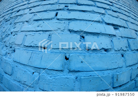 Large brick wall, painted in blue. Fisheye photo with pronounced distortion 91987550