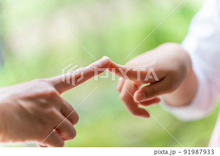 人差し指を合わせる女の子とお母さん 91987933