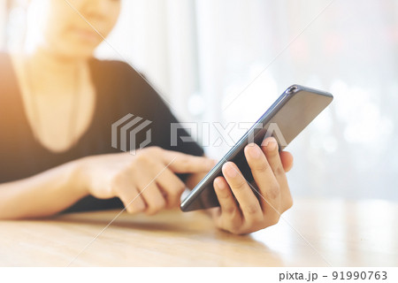 Close up image hand of woman using her mobile smartphone Close up image hand of woman using her mobile smartphone 91990763