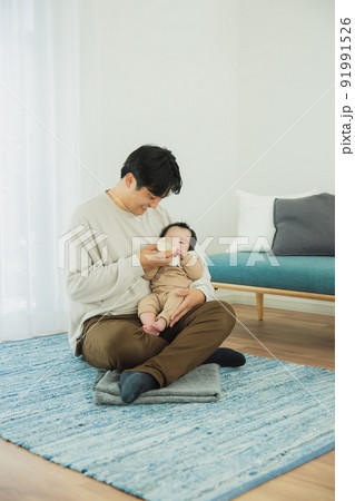 赤ちゃんにミルクをあげるパパ 91991526
