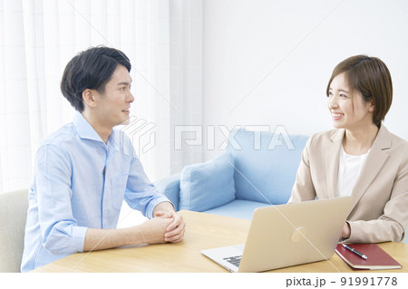 リビングでクライアントと話すセールスウーマン 91991778