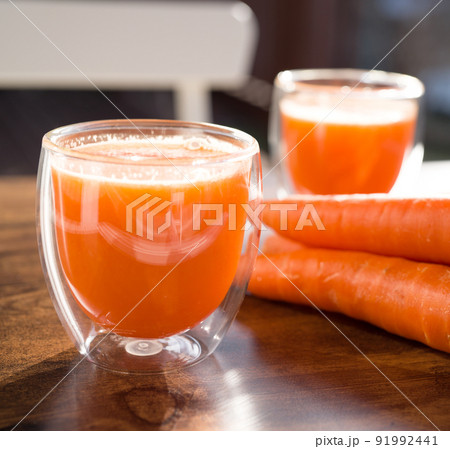Organic carrot juice in glass on dark wooden background 91992441