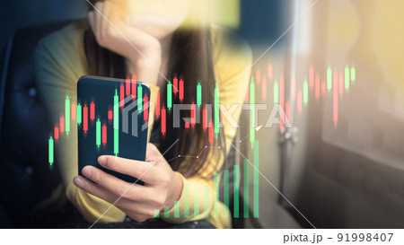 Financial technology and investment ideas with stock markets and mutual funds. Woman analyzing financial data with graph trading from smartphone at home. Financial technology and investment ideas with stock markets and mutual funds. Woman analyzing financial data with graph trading from smartphone at home. 91998407