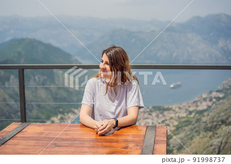 Woman tourist enjoys the view of Kotor. Montenegro. Bay of Kotor, Gulf of Kotor, Boka Kotorska and walled old city. Travel to Montenegro concept. Fortifications of Kotor is on UNESCO World Heritage Woman tourist enjoys the view of Kotor. Montenegro. Bay of Kotor, Gulf of Kotor, Boka Kotorska and walled old city. Travel to Montenegro concept. Fortifications of Kotor is on UNESCO World Heritage 91998737