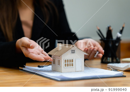 A woman holding and checking house model .Real Estate House Appraisal And Inspection and Insurance concept. 91999040