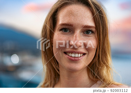 Portrait of a young beautiful woman in the summer city Portrait of a young beautiful woman in the summer city 92003112