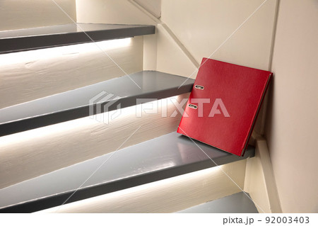 Red file on the stairs, selective focus Red file on the stairs, selective focus 92003403