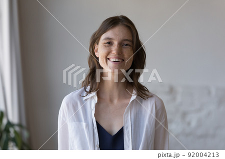 Woman with nice freckles on face smile staring at camera 92004213