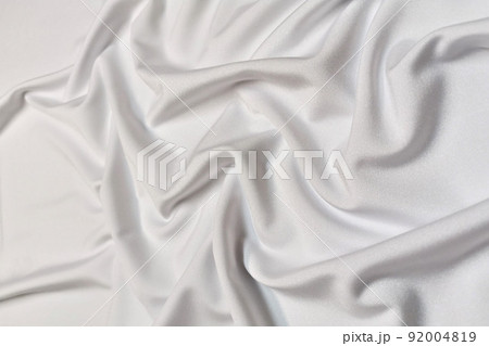 White supplex crumpled or wavy fabric texture background. Abstract linen cloth soft waves. Silk fabric. Smooth elegant luxury cloth texture. Concept for banner or advertisement. White supplex crumpled or wavy fabric texture background. Abstract linen cloth soft waves. Silk fabric. Smooth elegant luxury cloth texture. Concept for banner or advertisement. 92004819