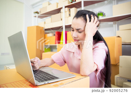 Frustrated and unhappy Asian woman entrepreneur in stressful emotion from economic disaster. Failure and mistake in online business entrepreneur. Frustrated and unhappy Asian woman entrepreneur in stressful emotion from economic disaster. Failure and mistake in online business entrepreneur. 92005276