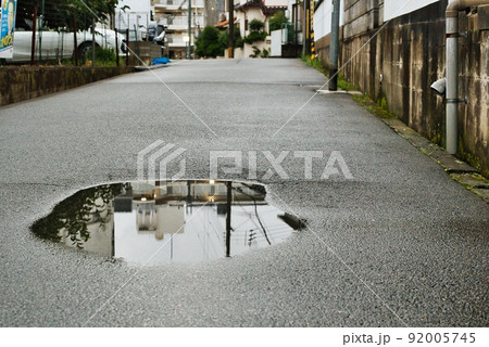 雨上がりの早朝の水たまりへの映り込み 雨上がりの早朝の水たまりへの映り込み 92005745