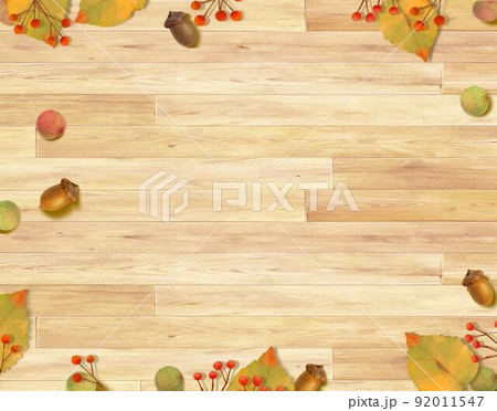 ぬくもりのある色調の木目の板の上に秋の紅葉した葉っぱと木の実のおしゃれな壁紙背景素材 92011547