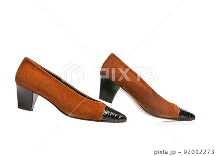 Brown suede ruby slipper isolated over white background. Woman's vintage style footwear. Concept of art, ad , 60s, 70s retro style fashion. Timeless classic Brown suede ruby slipper isolated over white background. Woman's vintage style footwear. Concept of art, ad , 60s, 70s retro style fashion. Timeless classic 92012273