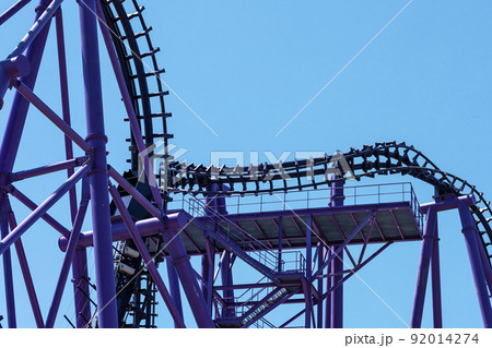 Lilac roller coaster against the blue sky. Extreme attraction in the amusement park Lilac roller coaster against the blue sky. Extreme attraction in the amusement park 92014274