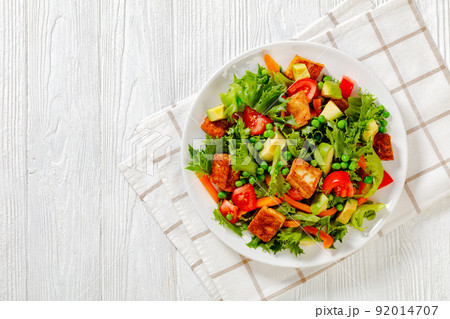 tofu salad with greens and vegetables on plate 92014707