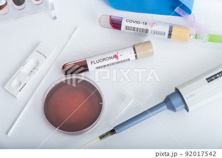 Blood samples of new variant OMICRON plus flu FLUORONA, covid19, coronavirus. Selective approach to the sample tube. 92017542