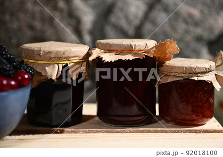 Collection of homemade jam from red currant, cherries and blackcurrant on a wooden surface. Canned food, canning concept Collection of homemade jam from red currant, cherries and blackcurrant on a wooden surface. Canned food, canning concept 92018100