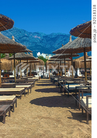 View of deck chairs and umbrellas on the sandy beach of Kemer, Turkey. View of deck chairs and umbrellas on the sandy beach of Kemer, Turkey. 92018338