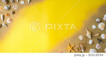 Composition frame for copy space, seashells, pebbles, mockup on yellow sand background. Blank, top view, still life, flat lay. sea vacation travel concept tourism and resorts. 92018594
