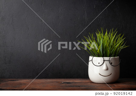 Potted plant with glasses on table and blackboard Potted plant with glasses on table and blackboard 92019142