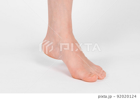 Barefoot and legs isolated on white background. Closeup shot of healthy beautiful female feet. Health and beauty concept. Side view of human foot ream with neutral manicure or pedicure. Sole of foot. Barefoot and legs isolated on white background. Closeup shot of healthy beautiful female feet. Health and beauty concept. Side view of human foot ream with neutral manicure or pedicure. Sole of foot. 92020124