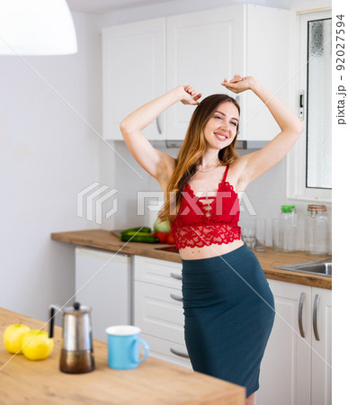 Woman dancing in kitchen at home 92027594