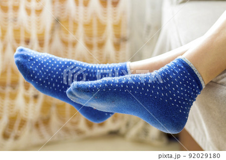 Woman feet in blue socks.Relaxing and comfort holiday concept. 92029180