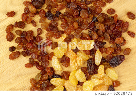 Raisins, close-up. The concept of healthy and organic nutrition. Snacks from dried fruits. Selective focus Raisins, close-up. The concept of healthy and organic nutrition. Snacks from dried fruits. Selective focus 92029475