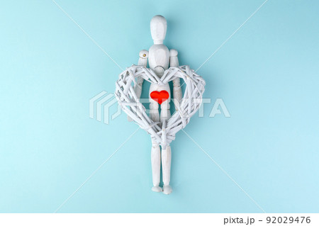 Love and Valentines Day concept. Wooden mannequin with a red heart. Love and Valentines Day concept. Wooden mannequin with a red heart. 92029476
