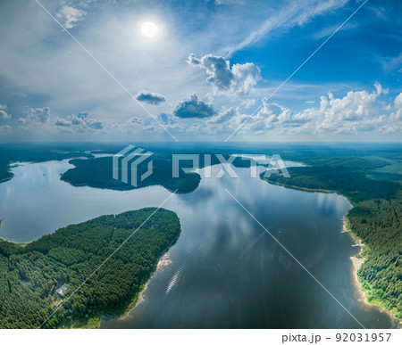 Big lake with green shores in bright sun light, aerial landscape. Recreation concept. Aerial view 92031957