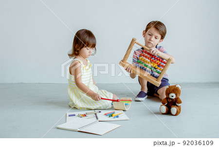 Little boy and girl playing together at school Little boy and girl playing together at school 92036109