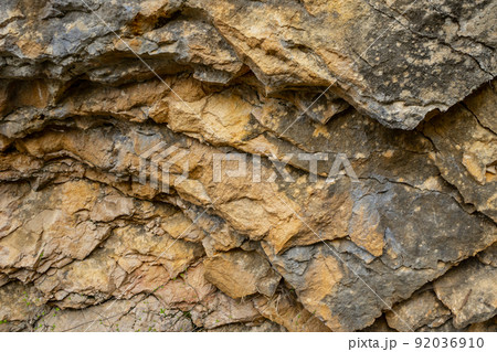 Background texture of a cracked triangle rock in a natural park Background texture of a cracked triangle rock in a natural park 92036910