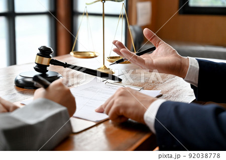 Male lawyer or business legal consultant giving an advice and counselling with his client Male lawyer or business legal consultant giving an advice and counselling with his client 92038778
