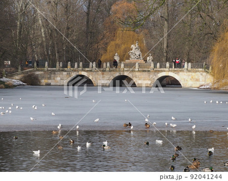Stony bridge at baths park in european Warsaw city of Poland 92041244