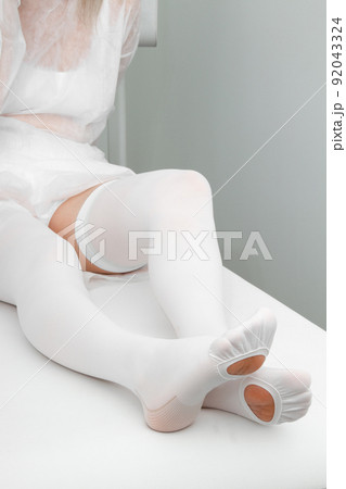 Anti-embolic Compression Hosiery for surgery isolated on white. Medical white stockings, tights for varicose veins and venouse therapy. Thrombo embolic deterrent hose or anti-embolism stockings. 92043324