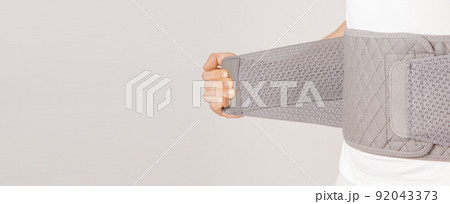 Lumbar brace on the human body isolated on a white background. Trauma of back. Back brace, orthopedic lumbar, support belt for back muscles. Lower back problems health. Lumbar brace on the human body isolated on a white background. Trauma of back. Back brace, orthopedic lumbar, support belt for back muscles. Lower back problems health. 92043373