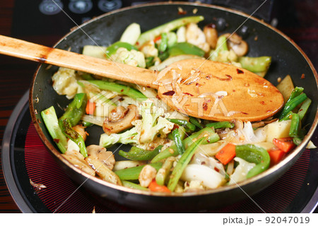 cooking fresh vegetable in a cooking pan  92047019