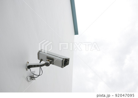 CCTV security camera operating outdoor  92047095