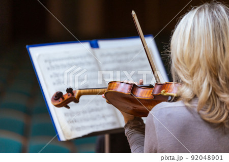 Philharmonic orchestra playing on the violoncello, performance concert, classical music concept 92048901